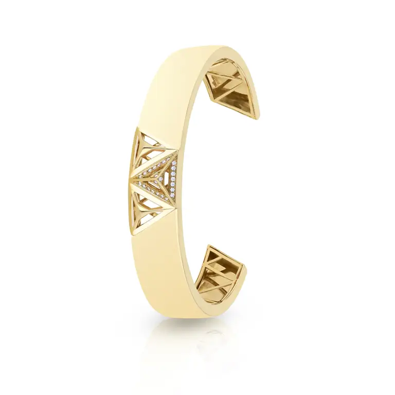 A must-have accessory, the monogram gold bangle is made up of triangular shapes and intricately finished with pavé diamonds